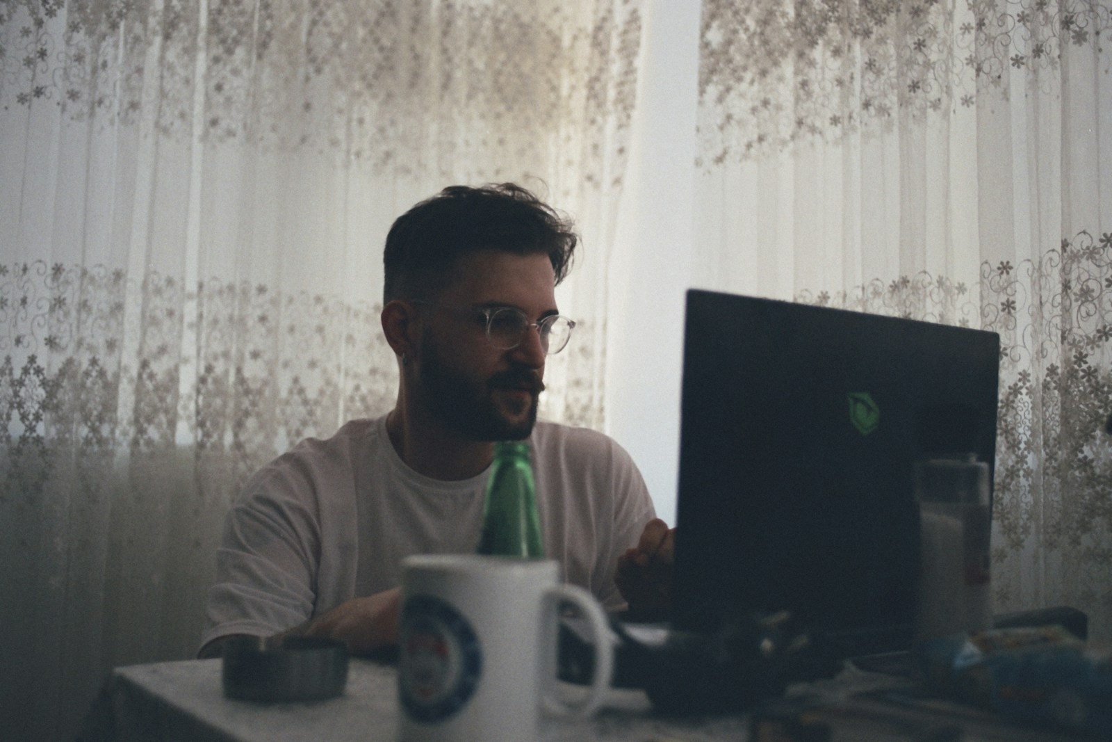 a man sitting in front of a laptop computer
